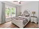 Cozy bedroom with large window, stylish bedframe, and decorative lamps on matching bedside tables at 212 Forest Walk Way, Mooresville, NC 28115