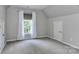 Well-lit bedroom with neutral walls, carpet, and a bright window for natural light at 212 Forest Walk Way, Mooresville, NC 28115