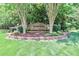 A landscaped entrance to the Cherry Grove community with a brick sign and mature trees at 212 Forest Walk Way, Mooresville, NC 28115