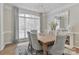 Bright dining room featuring neutral colors, a modern chandelier, and a decorative mirror above the buffet at 212 Forest Walk Way, Mooresville, NC 28115