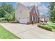 Two-story home with a brick and siding exterior, featuring a spacious driveway and landscaping at 212 Forest Walk Way, Mooresville, NC 28115