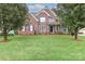 Traditional brick home with a well-manicured lawn and mature landscaping, perfect for curb appeal at 212 Forest Walk Way, Mooresville, NC 28115