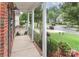 Charming porch with white columns offering a view of the landscaped front yard and quiet street at 212 Forest Walk Way, Mooresville, NC 28115