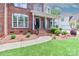 Inviting front porch with classic columns and brick accents, enhancing the home's charm at 212 Forest Walk Way, Mooresville, NC 28115