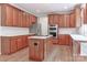 Cherry cabinets and marble countertops highlight this kitchen's modern island and stainless appliances at 212 Forest Walk Way, Mooresville, NC 28115