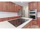 Kitchen island with stovetop, marble countertops, stainless steel appliances, and plenty of cabinets at 212 Forest Walk Way, Mooresville, NC 28115