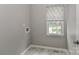 Practical laundry room with a window, neutral colors, and tile flooring at 212 Forest Walk Way, Mooresville, NC 28115