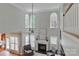 A bright living room with tall windows, a fireplace, and two comfortable gray chairs for relaxing and entertaining at 212 Forest Walk Way, Mooresville, NC 28115
