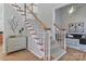 Elegant staircase with wood and white trim, leading to the upper level, complemented by stylish decor at 212 Forest Walk Way, Mooresville, NC 28115