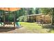 Backyard with a swing set, umbrella-covered table, and landscaping offers outdoor enjoyment at 217 Eighth Ave, New London, NC 28127