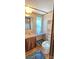Bathroom features vanity, mirror, toilet and built-in storage shelves at 217 Eighth Ave, New London, NC 28127