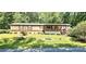 Home exterior with a cozy front porch and a well-manicured lawn with mature landscaping at 217 Eighth Ave, New London, NC 28127