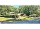 Charming single-story home with a welcoming front porch and mature trees surrounding the property at 217 Eighth Ave, New London, NC 28127