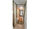 Hallway featuring neutral paint, tile flooring, and access to bedrooms and bathrooms at 217 Eighth Ave, New London, NC 28127
