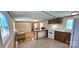 Eat-in kitchen features white appliances, tile floor and an open view into the living area at 217 Eighth Ave, New London, NC 28127