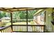 Welcoming covered porch with wood accents, offering a serene view of the landscaped yard at 217 Eighth Ave, New London, NC 28127