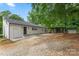 Back exterior view of home, with gravel area and carport in backyard at 2376 S Us 321 Hwy, Newton, NC 28658