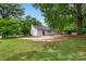 Backyard with green space, gravel area, storage shed, and carport at 2376 S Us 321 Hwy, Newton, NC 28658