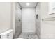 Updated bathroom showcasing walk-in shower with textured tile surround and modern fixtures at 2376 S Us 321 Hwy, Newton, NC 28658