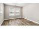 Bedroom with wood-look flooring, neutral paint, and natural light from two windows at 2376 S Us 321 Hwy, Newton, NC 28658