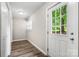 Light-filled entryway with white door, wood-look flooring, and window views of the yard at 2376 S Us 321 Hwy, Newton, NC 28658