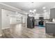 Open layout between living room and kitchen with gray cabinets, granite countertops, stainless appliances at 2376 S Us 321 Hwy, Newton, NC 28658