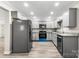 Renovated kitchen featuring stainless steel appliances, granite countertops, and gray shaker cabinets at 2376 S Us 321 Hwy, Newton, NC 28658