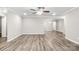 Large, open living room with crown molding, ceiling fan and gray wood-look floors at 2376 S Us 321 Hwy, Newton, NC 28658