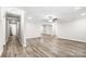 Large, open living room with crown molding, ceiling fan and gray wood-look floors at 2376 S Us 321 Hwy, Newton, NC 28658