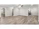 Large, open living room and kitchen with gray wood-look floors at 2376 S Us 321 Hwy, Newton, NC 28658
