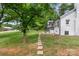 Exterior shot with brick pathway to house, green yard, and mature tree at 2376 S Us 321 Hwy, Newton, NC 28658