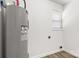 Utility room with water heater, window, and light-colored flooring at 2376 S Us 321 Hwy, Newton, NC 28658