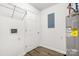Spacious utility room features water heater, shelving, and electric panel at 2376 S Us 321 Hwy, Newton, NC 28658