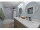 Stylish bathroom with double sink vanity, round mirrors, and patterned shower tile at 2502 Cranbrook Ln # 8, Charlotte, NC 28207