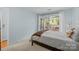 Relaxing bedroom offers access to a private balcony with outdoor seating at 2502 Cranbrook Ln # 8, Charlotte, NC 28207