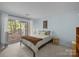 Cozy bedroom with sliding glass doors to balcony and neutral decor at 2502 Cranbrook Ln # 8, Charlotte, NC 28207