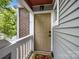 Inviting condo entrance featuring a covered porch and stylish front door at 2502 Cranbrook Ln # 8, Charlotte, NC 28207