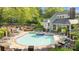 Inviting community pool and hot tub surrounded by lounge chairs, landscaping, and seating areas at 2502 Cranbrook Ln # 8, Charlotte, NC 28207