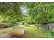 Lush, private backyard with mature trees, sheds, and ample green space for outdoor activities at 2556 Salem Church Rd, Lincolnton, NC 28092