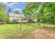 Spacious backyard with a partial fence, grassy lawn, and shed at 2556 Salem Church Rd, Lincolnton, NC 28092