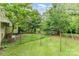 Large grassy backyard with partial fence line and shed at 2556 Salem Church Rd, Lincolnton, NC 28092