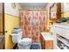 Bathroom featuring tile walls, a pedestal sink, and an enclosed toilet at 2556 Salem Church Rd, Lincolnton, NC 28092