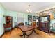 Charming dining room with hardwood floors, vintage chandelier, and ample natural light at 2556 Salem Church Rd, Lincolnton, NC 28092