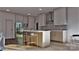 Bright kitchen features a spacious island with seating, stainless steel appliances, and custom cabinetry at 2601 Greenmont Cir, Belmont, NC 28012