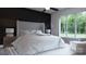 Calming main bedroom with a large window, soft lighting, and minimalist decor at 2601 Greenmont Cir, Belmont, NC 28012
