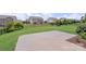 Well-manicured backyard with a patio, green lawn, and black metal fence at 3211 Gilroy Dr, Fort Mill, SC 29707