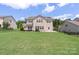 A view of the backyard and the back of the house, with a beautiful lawn at 3211 Gilroy Dr, Fort Mill, SC 29707
