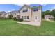 A backyard featuring a concrete patio, lush green grass, and a light beige home at 3211 Gilroy Dr, Fort Mill, SC 29707