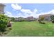 Expansive backyard with lush green lawn, manicured landscaping, and a black metal fence at 3211 Gilroy Dr, Fort Mill, SC 29707