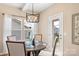 A dining room features a wood table and light fixture along with natural light from windows at 3211 Gilroy Dr, Fort Mill, SC 29707